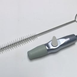 Suction adapter with cleaning brush